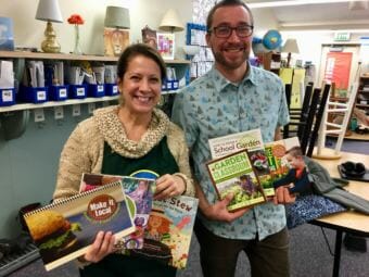 Karen Goodell and master gardener Joel Bos show off prizes from winning the Alaska DNR Farm to School Challenge, on Dec. 4, 2018. (Photo by Zoe Grueskin/KTOO)