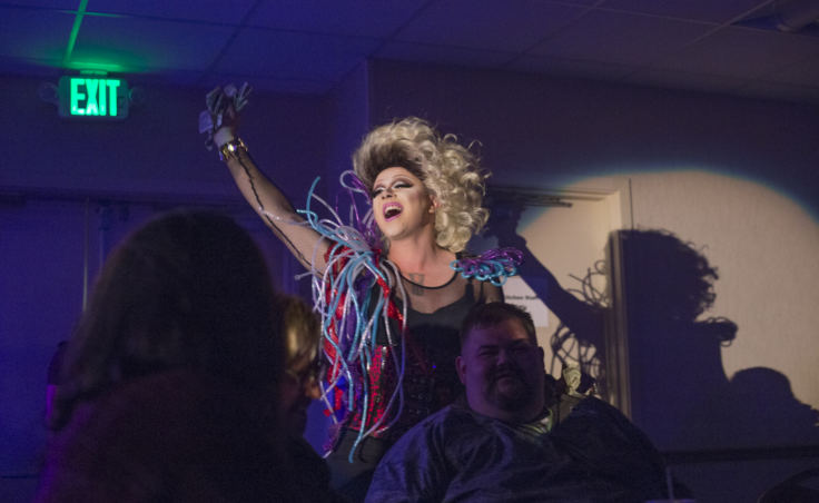 Dancing to Cyndi Lauper, Juneau artist Ricky Tagaban performs as the drag queen Lituya Hart greeting Tlingit & Haida President Richard Peterson at the “Besties for Breasties” drag show and medical fundraiser on September 21, 2018 at Elizabeth Peratrovich Hall in Juneau. The event may be the first drag show to be sponsored by a tribal government.