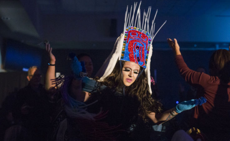 Performing as the drag persona Lituya Hart, Tlingit artist Ricky Tagaban wears a Shakee.át headress made created from glitter foam, duct tape, ermine, rabbit fur, and zip ties in place of sea lion whiskers.