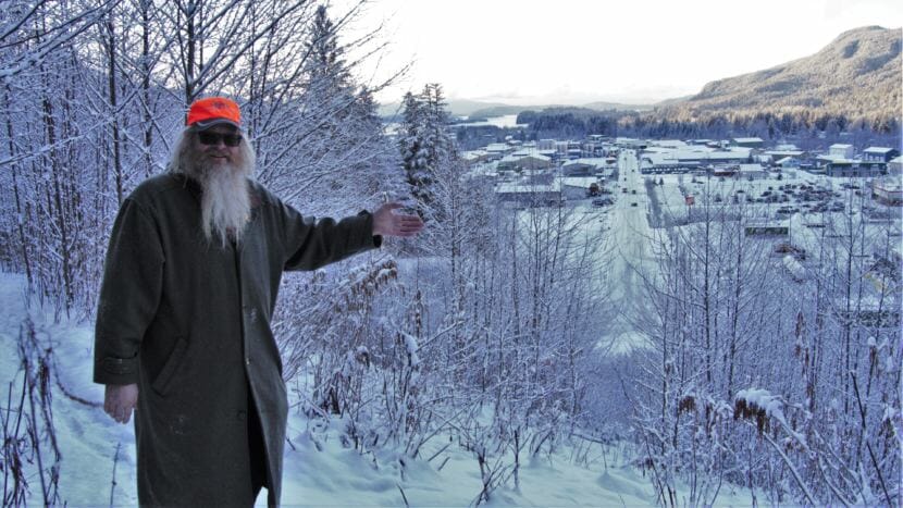 Garritt McLean explains how he applied his expertise as a surveyor to lay out a peace sign on the hill at the end of Commercial Boulevard in Juneau on Jan. 8, 2019. McLean made the guerilla art in 2008 after working on the construction of Home Depot.