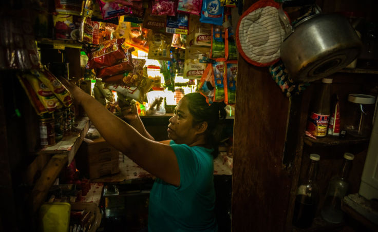 Nimfa Manlabe, 46, boosts her income by selling consumer goods in sachets from her sari-sari store in her home in Manila. This is a common way for Filipinos to get their daily supplies. (Photo by Jes Aznar for NPR)