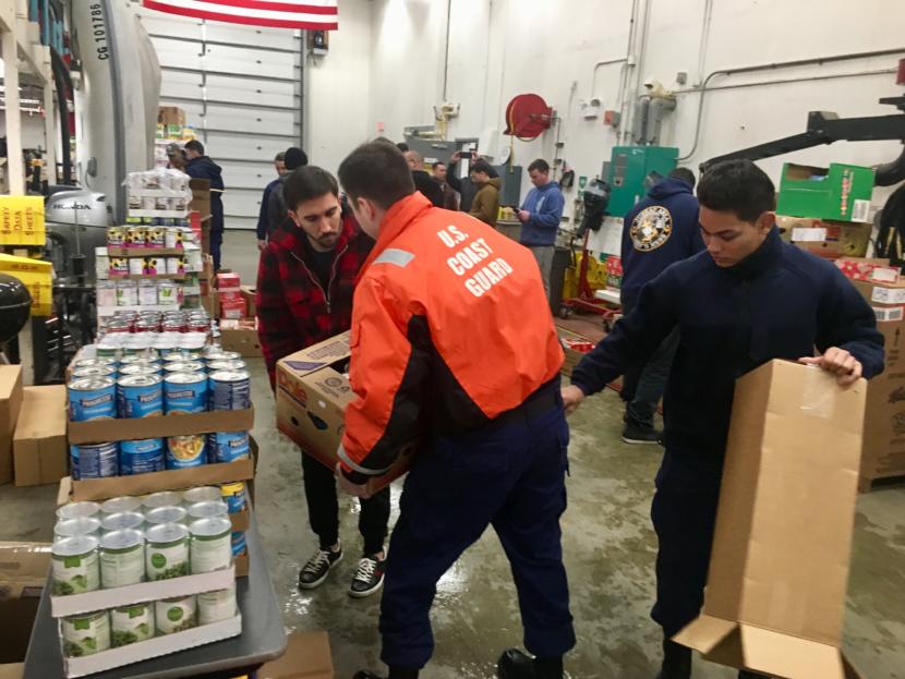 Coast Guard members unpack donations to the consumables pantry on Jan. 22, 2019. (Photo by Zoe Grueskin/KTOO)