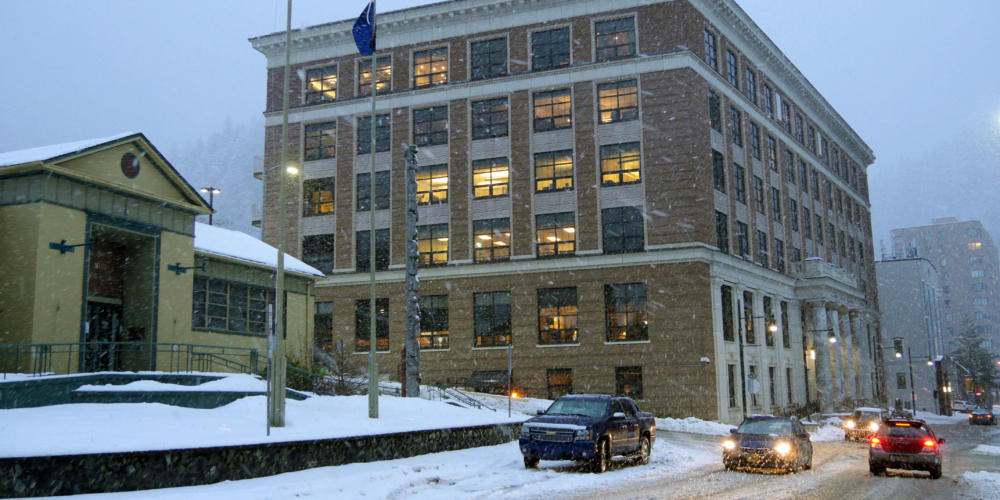 Snow falls on the Alaska State Capitol in Juneau on Feb. 18, 2019.