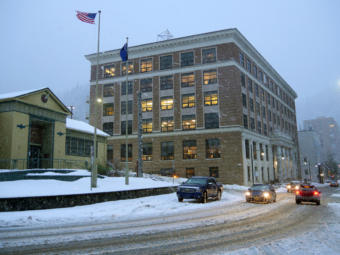 Snow falls on the Alaska State Capitol in Juneau on Feb. 18, 2019.