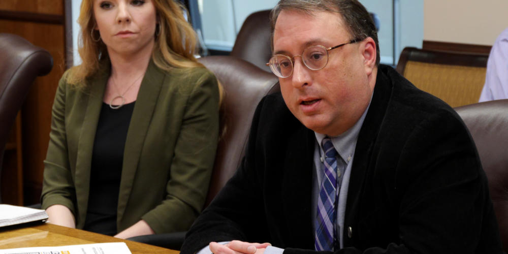 Policy Director Mike Barnhill of the Office of Management and Budget answers a reporter’s question about the most recent version of Gov. Michael Dunleavy’s state operating budget in the governor’s cabinet room in the Capitol in Juneau on Feb. 13, 2019. OMB Deputy Director Laura Cramer, is seated next to him. They were at a budget briefing held for the press.