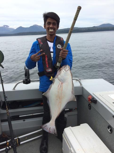Mohan Raj Arul shows off the halibut he caught while fishing with his host family. (Photo used with permission)