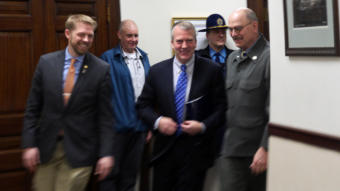 U.S. Senator Dan Sullivan rounds a corner on the second floor of the Alaska Capitol on his way to deliver his annual address to the Alaska Legislature Feb. 21. 2019. He was escorted, just before entering the House chambers, by Rep. Josh Revak, R-anchorage, left, and Sen. Click Bishop, R-Fairbanks, right. (Photo by Skip Gray/360 North)