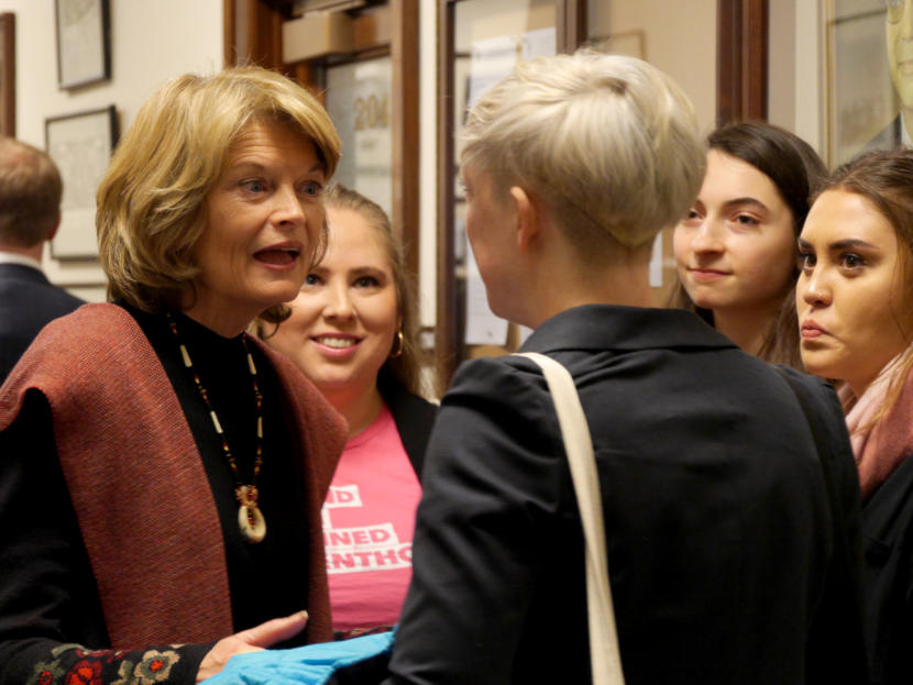 U.S. Sen. Lisa Murkowski, R-Alaska, chats in the Alaska Capitol with members of Planned Parenthood Teen Council and Generation Action, a Planned Parenthood group of college students. The council is made up of teens from Juneau and Anchorage. The Generation Action members are from Anchorage and Fairbanks. They talked in a hallway moments before Murkowski gave her annual address to the Alaska Legislature, Feb. 19, 2019.