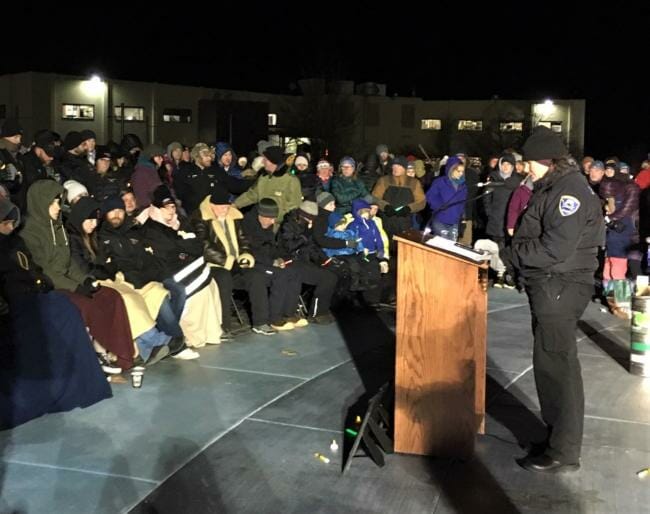 Friends and family of the missing Guardian Flight crew members sit surrounded by community members at a remembrance ceremony at Overstreet Park on Friday, Feb. 2, 2019. (Photo by Adelyn Baxter/KTOO)