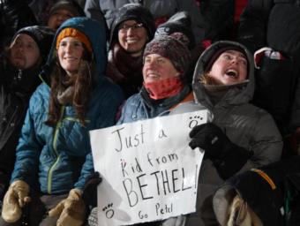 Mushing fans from Bethel (left to right) Ashley Fairbanks Glasheen, Rachel DeHaan, and Madelene Reichard cheer Pete Kaiser on in Nome as he wins the Iditarod Race on March 13, 2019. (Photo by Zachariah Hughes/APRN)
