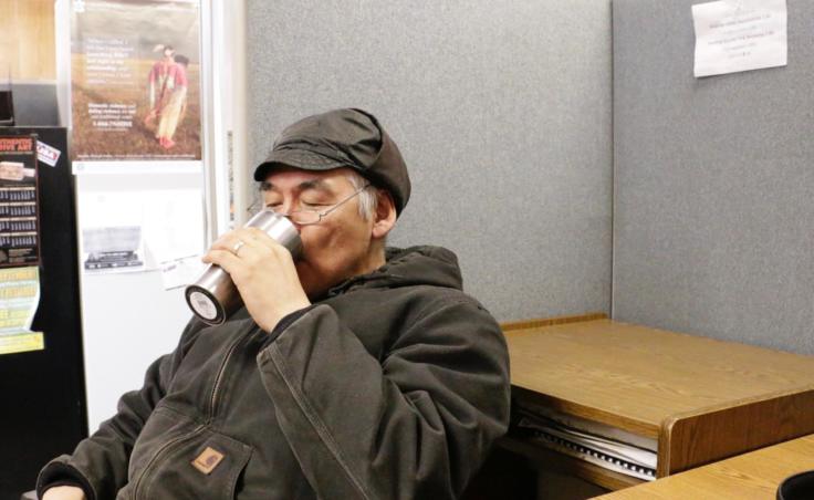 Eek's Tribal Council President drinks coffee brewed with rain water in the Eek tribal/city office building on February 21, 2019. The office keeps a rain barrel inside the building. (Photo by Anna Rose MacArthur/KYUK)
