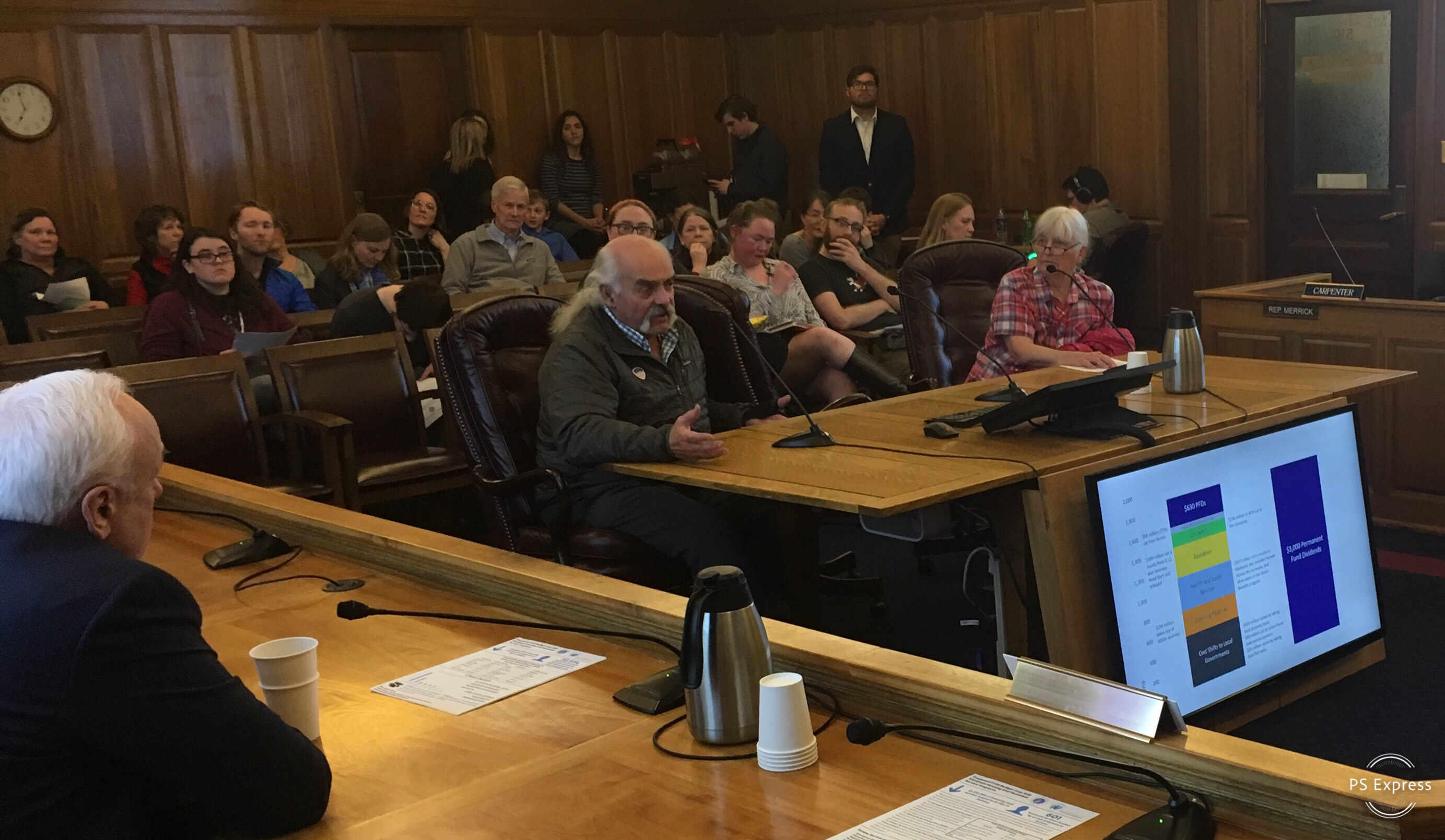 Jon and Lesley Lyman testify against Gov. Mike Dunleavy's proposed budget reductions to members of the House Finance Committee on Friday. The meeting was the first of several that committee members are holding this weekend. Dunleavy will have his own budget road show next week. (Photo by Andrew Kitchenman/KTOO and Alaska Public Media)