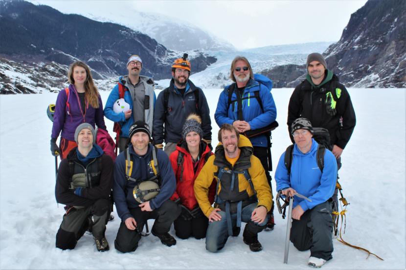 Matt Brown (back row, second from right) poses with members of Juneau's Hidden History, an exploring club, after a climb on the glacier. (Photo by Adelyn Baxter/KTOO)