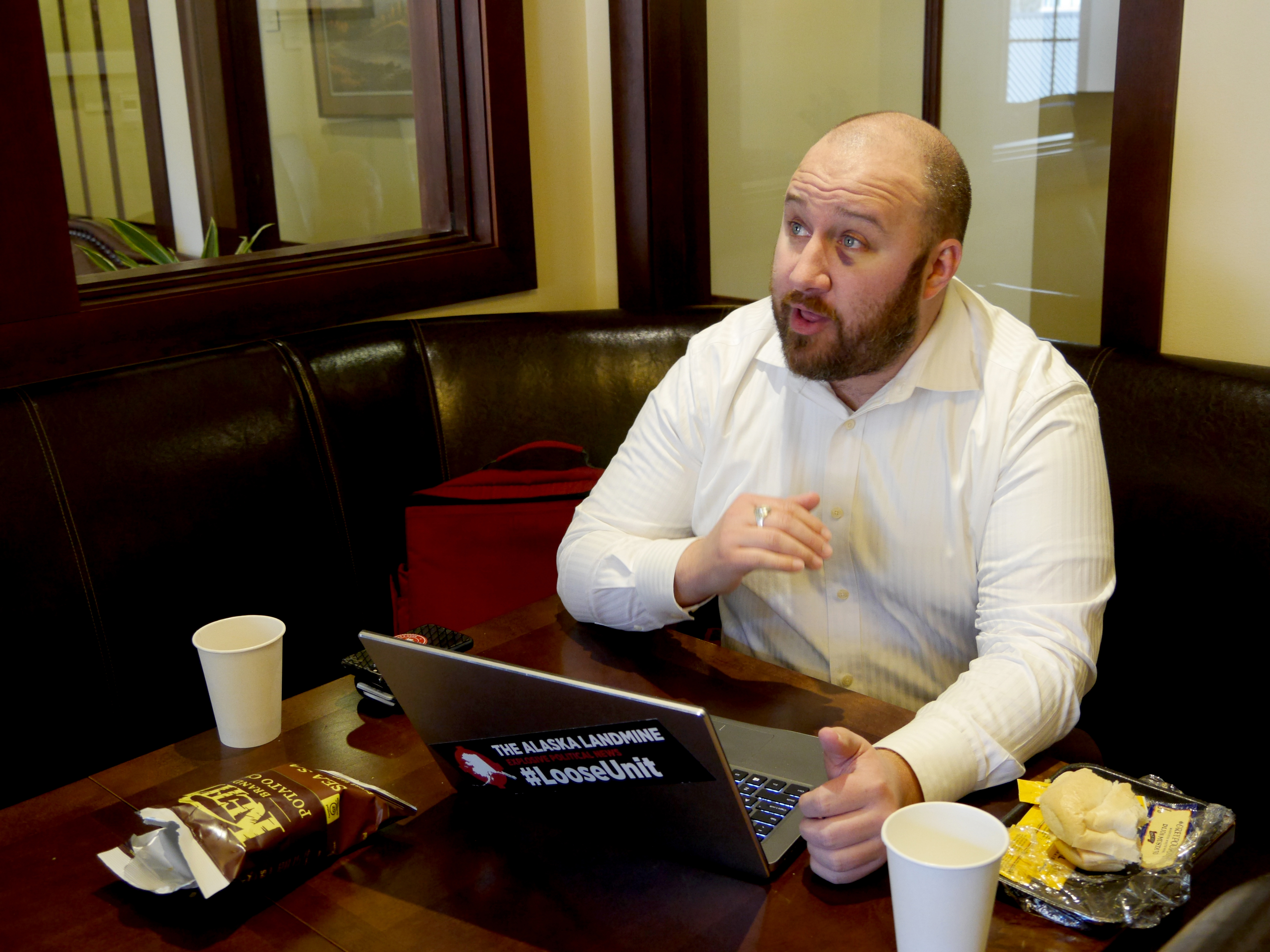Blogger Jeff Landfield of The Alaska Landmine works from his “office,” a public lounge in the Capitol in Juneau while talking with Alaska's Energy Desk reporter Nat Herz on March 25, 2019. Landfield said a legislative staffer gave him the black eye at a bar on March 22.