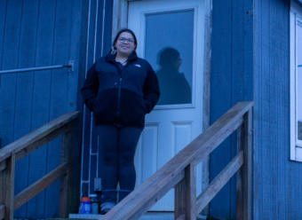 Serafima Edelen stands in front of her house on St. Paul island in January, 2019.