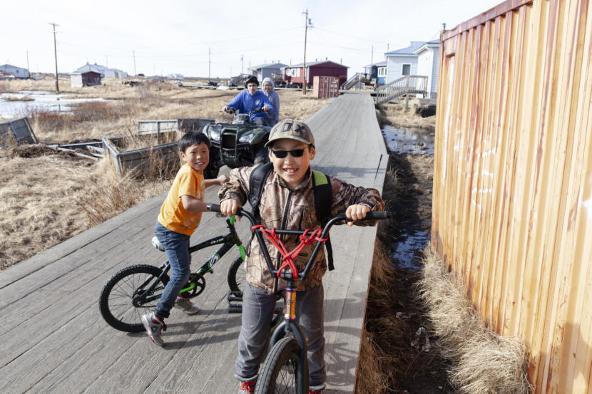 Kids play on the boardwalk that snakes through town on Wednesday, April 3, in Tuntutuliak, Alaska. (Photo by Rashah McChesney)