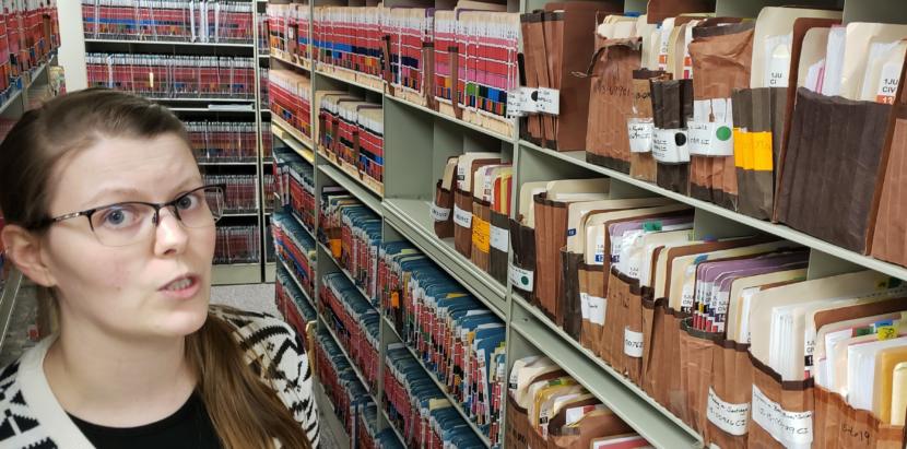 Records clerk Amanda Beebe-Bay explains parts of the court system's case filing and records management system in the clerk's office of the Dimond Courthouse in Juneau on April 22, 2019. Folders are color-coded by case type, different stickers correspond to specific judges, and case numbers are also color-coded by year.