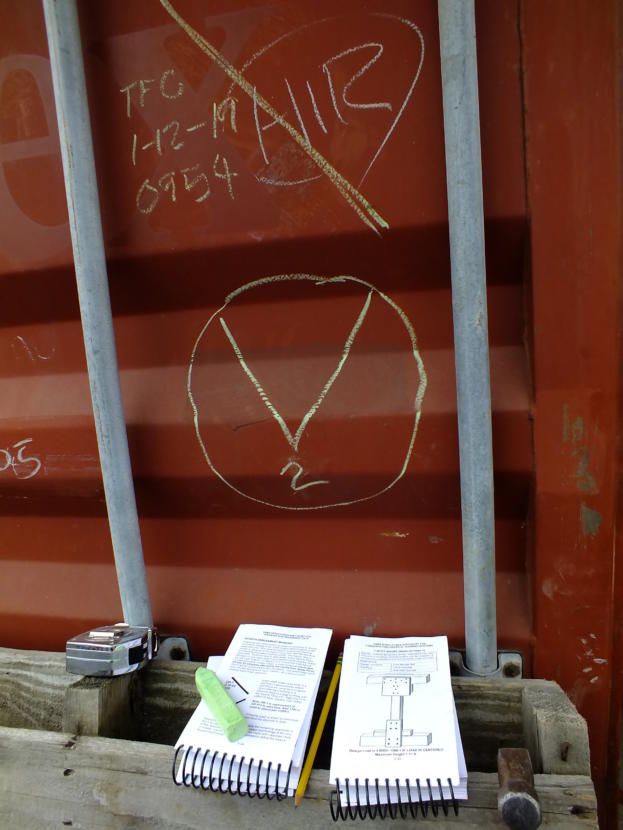 Chalk markings indicate structural damage and number of trapped victims. Manuals (bottom) define each marking and show how to make wooden T-spot shoring for reinforcing damaged building entrances.