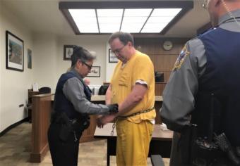 Doug Edwards is handcuffed following his sentencing hearing on April 18, 2019, in Ketchikan Superior Court.
