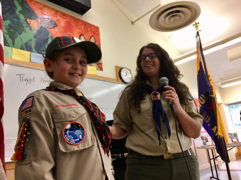 Kelsie Powers (left) receives her Arrow of Light, the highest award a Cub Scout can earn, at a pack meeting on April 20, 2019. Her den leader, Emily Lockie (right) presented the award. Of Kelsie, she said, "She’s a great leader, she’s empathetic, and she’s so good at standing up for what is right." (Photo by Zoe Grueskin/KTOO)