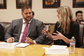 Department of Health and Social Services Commissioner Adam Crum talks to Department of Public Safety Commissioner Amanda Price before a cabinet meeting with Gov. Mike Dunleavy, on Tuesday, January 8, 2019, in Juneau, Alaska. (Photo by Rashah McChesney/Alaska's Energy Desk)