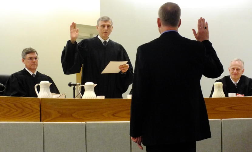 Senior Superior Court Judge Donald Hopwood administers the oath of office to Juneau Superior Court Judge Daniel Schally during his installation ceremony March 29, 2019 at the Dimond Courthouse. Alaska Supreme Court Chief Justice Joel Bolger (left) and Juneau Superior Court Judge Philip Pallenberg (right) look on.