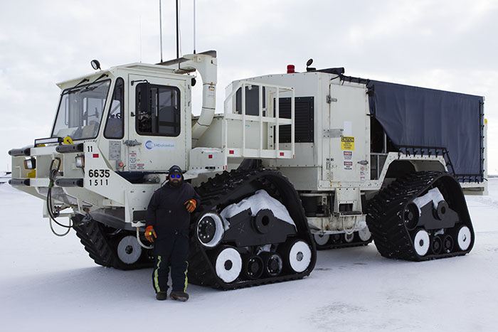 A worker stands in front of a vibe truck being used as part of BP’s 3-D seismic program at Prudhoe Bay this winter.