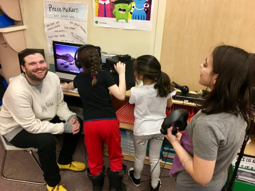 T.J. Cramer (left), stage name Manner, on March 26, 2019 with three of the Riverbend Elementary School students he's working with to produce a student-created album. (Photo by Zoe Grueskin/KTOO)