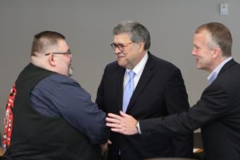 U.S. Attorney General William Barr, center, shakes hands with Richard Peterson, president of the Central Council of the Tlingit and Haida Indian Tribes of Alaska, in Anchorage on May 29, 2019. U.S. Sen. Dan Sullivan, R-Alaska, is at right.