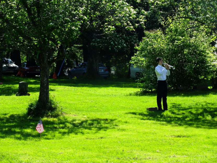 Sam Marnon, a rising sophomore at Juneau Douglas High School, plays taps during the Memorial Day service at Evergreen Cemetery on May 27, 2019.