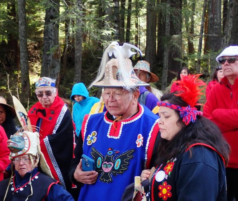 Hoonah community members Bill Wilson, Kenny Grant and Heather Powell hold a traditional Tlingit ground blessing for the site of a second cruise ship dock being built in partnership with Norwegian Cruise Lines and Huna Totem Corporation.