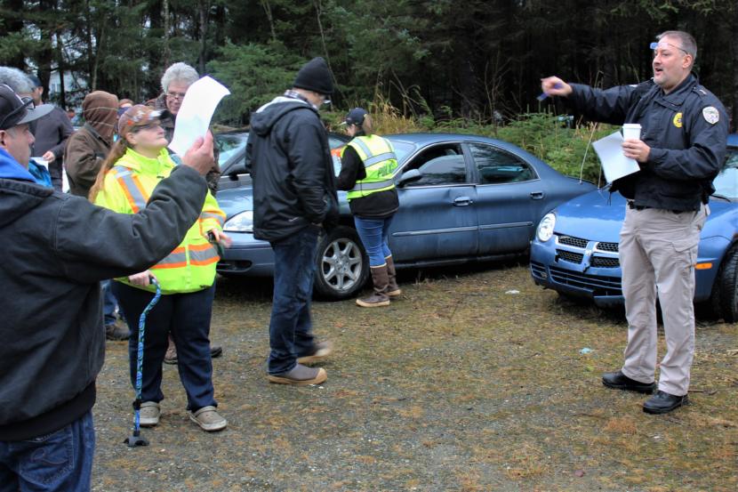 Juneau Police Department Deputy Chief David Campbell serves as the auctioneer at a police car auction in the city's Lemon Creek impound lot in November 2018.