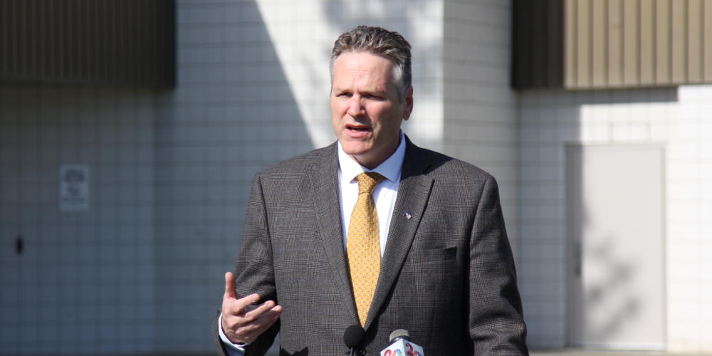 Alaska Gov. Mike Dunleavy speaks at a press conference in front of Wasilla Middle School.