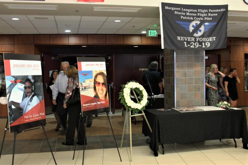 Signs remember Guardian Flight crew members Patrick Coyle and Margaret Langston during a memorial service on Friday, June 7, 2019. (Photo by Adelyn Baxter/KTOO)