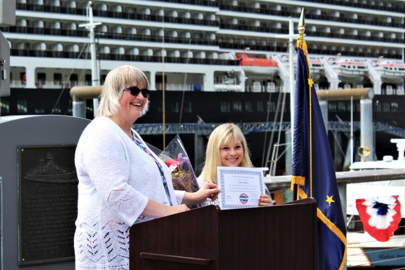 Mayor Beth Weldon presents Ashley DeRamus with a certificate honoring her for being the first person with Down Syndrome to sing the national anthem in all 50 states. (Photo by Adelyn Baxter/KTOO)
