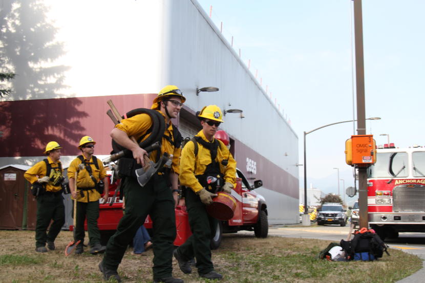 Wildland firefighters prepare to head into the woods in East Anchorage on Tuesday, July 2, 2019, to fight a fire that forced evacuations of a trailer park and two other areas of the city.