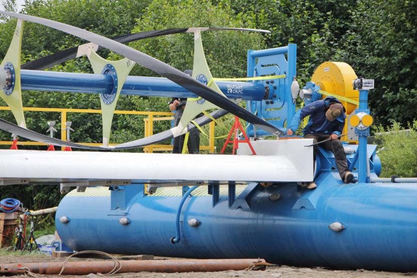 ORPC workers set the RivGen's turbines, July 2019. (Photo by Isabelle Ross/KDLG)