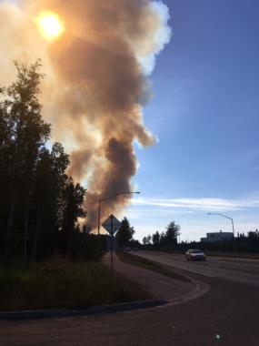 Smoke rises in the distance near Anchorage.