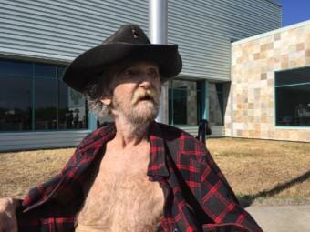 Anchorage resident Bill Smith, 78, waits at Wendler Middle School after being evacuated from his home in Manoog’s Isle trailer park as a brush fire burned on July 2, 2019.