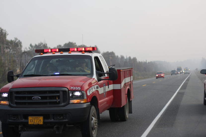A Chugiak Volunteer Fire and Rescue Company firefighter passes traffic along the Parks Highway on Tuesday, Aug. 20, 2019.