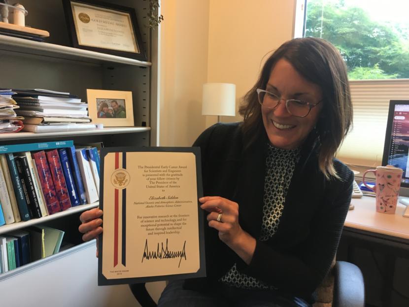Elizabeth Siddon in her office on Aug. 1, 2019, displays her Presidential Early Career Award for Scientists and Engineers (Photo by Zoe Grueskin/KTOO)