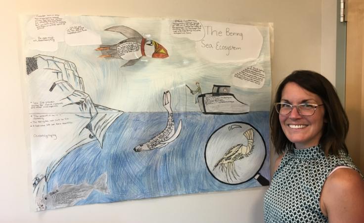 Elizabeth Siddon worked with a life sciences teacher at Floyd Dryden Middle School to develop a 6-week curriculum to explore the Bering Sea marine ecosystem. A poster created by students hangs on her office wall, photographed on Aug. 1, 2019. (Photo by Zoe Grueskin/KTOO)