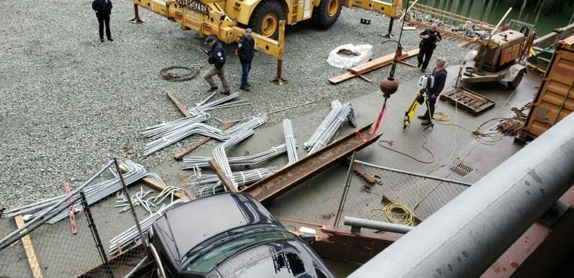 Juneau police officers investigate how this SUV plowed through the wall of the Marine Parking Garage in downtown Juneau and into an active construction zone on Monday, Sept. 23, 2019. An eyewitness says one worker was pinned under the steel beam.