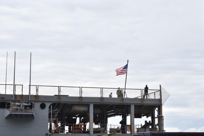 U.S. Navy personnel stand on the flight deck of the USS Comstock, docked in Kodiak, Sept. 10, 2019.