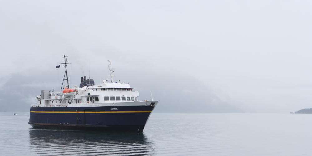 The Aurora, a 235-foot Alaska state ferry, approaches the dock in Whittier, its departure point for its trip across Prince William Sound to Cordova. (Photo by Nat Herz/Alaska's Energy Desk)