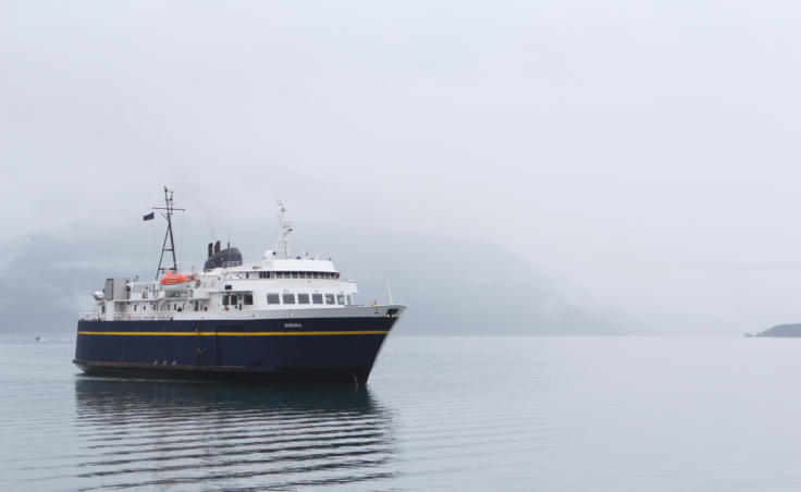 The Aurora, a 235-foot Alaska state ferry, approaches the dock in Whittier, its departure point for its trip across Prince William Sound to Cordova. (Photo by Nat Herz/Alaska's Energy Desk)
