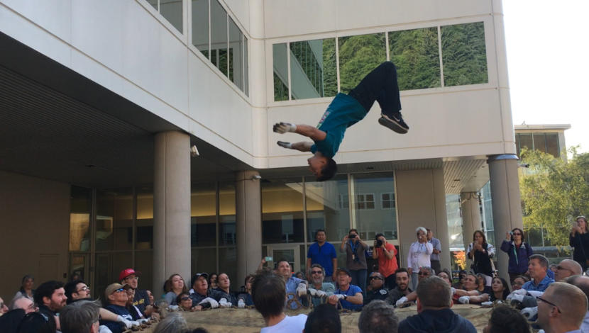 Kyle Worl does a back flip during a blanket toss in Juneau on Aug. 29, 2019. (Photo by Zoe Grueskin/KTOO)