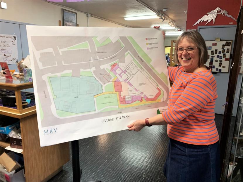 Juneau Arts and Humanities Council Executive Director Nancy DeCherney holds an aerial view of the design for the New JACC. (Photo by Adelyn Baxter/KTOO)