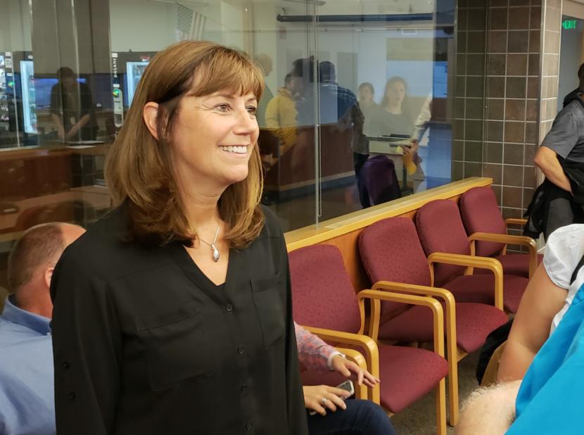 Bridget Weiss smiles as she's congratulated on her appointment to interim superintendent of the Juneau School District at a meeting of the Juneau School Board on Aug. 6, 2018. (Photo by Jeremy Hsieh/KTOO)