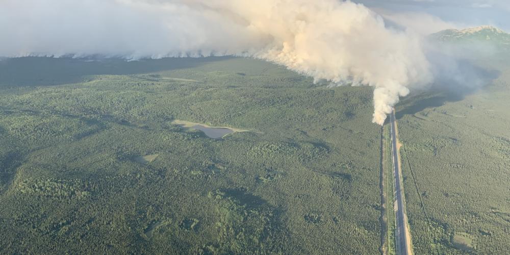A plume of smoke rises near the Sterling Highway in this aerial photo.